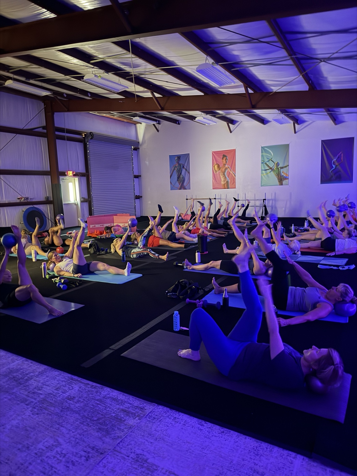 Women doing a group barre workout with exercise balls in the Johns Island studio
