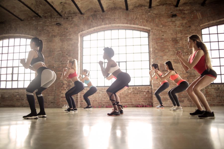 Stock photo of women doing a guided group exercise session
