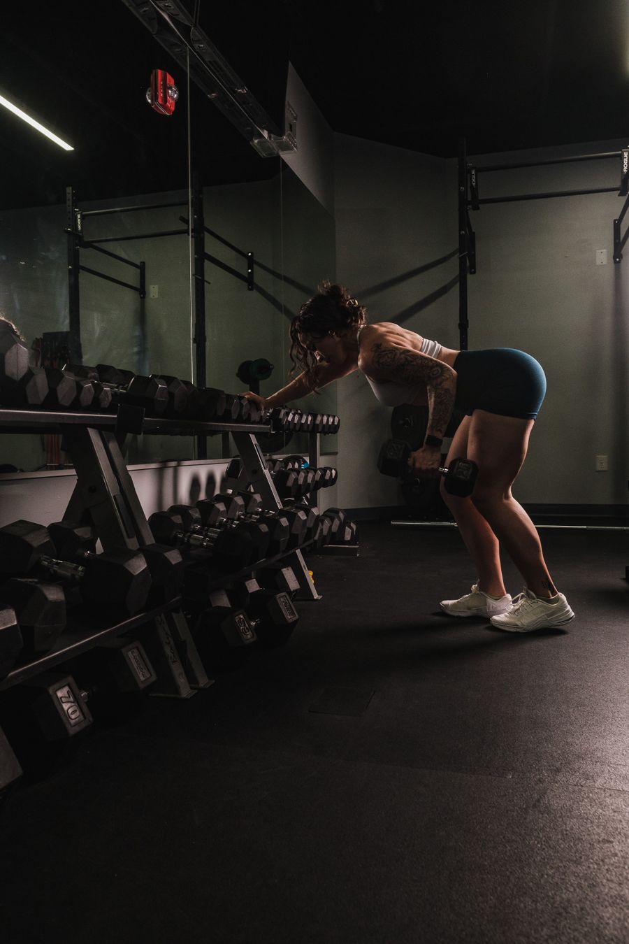 Stock photo of a woman working with dumbbells in a gym
